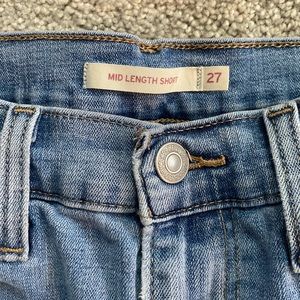 Levi mid length high waisted slightly ripped jean shorts